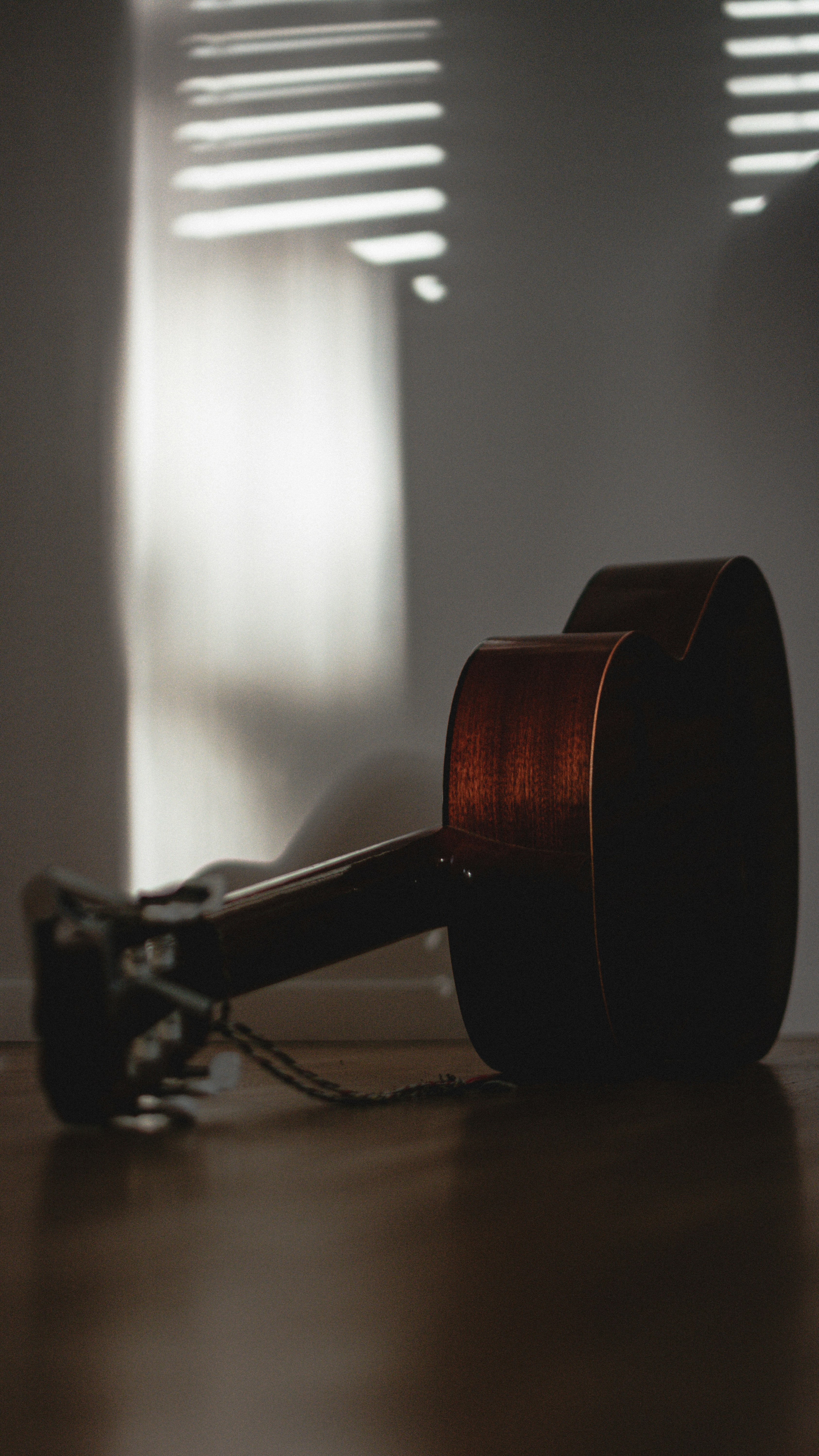 a guitar laying on the floor in a room