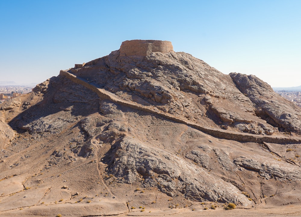 a large rock formation in the middle of a desert