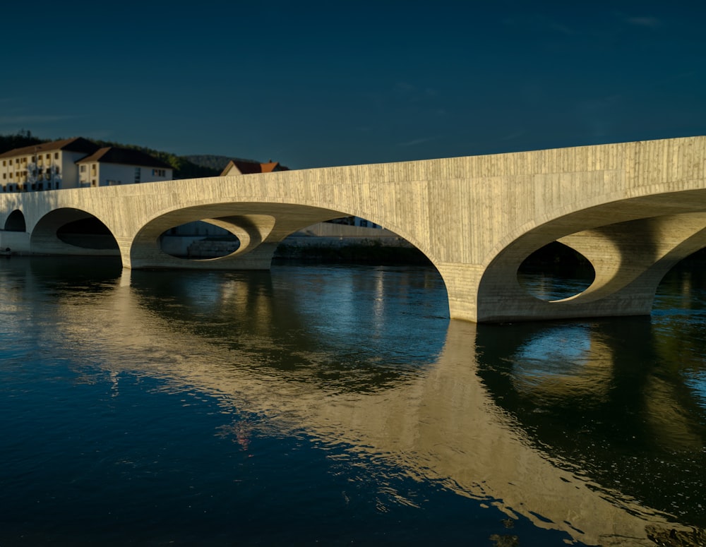 a bridge over a body of water with buildings in the background