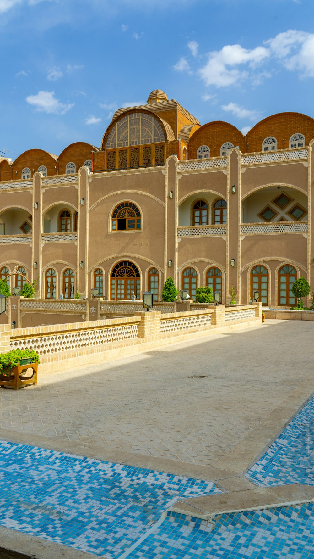 a large building with a pool in front of it