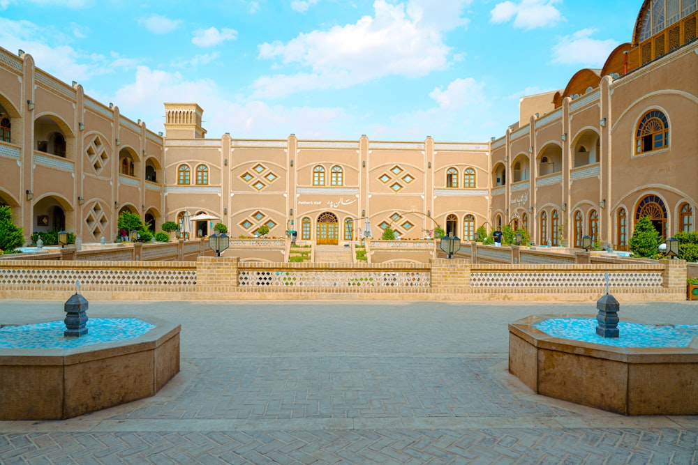 a large building with a fountain in front of it