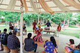 An outdoor cultural festival showcasing traditional music and dance under colorful tents.