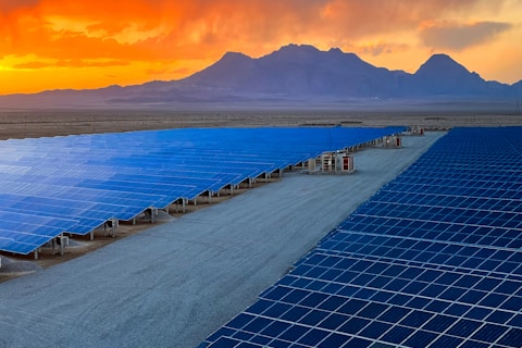 a large array of solar panels in a desert