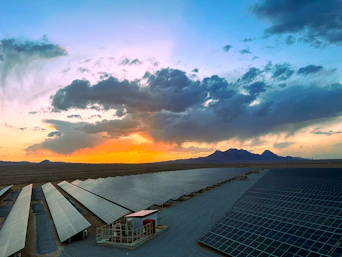 a large array of solar panels in a desert