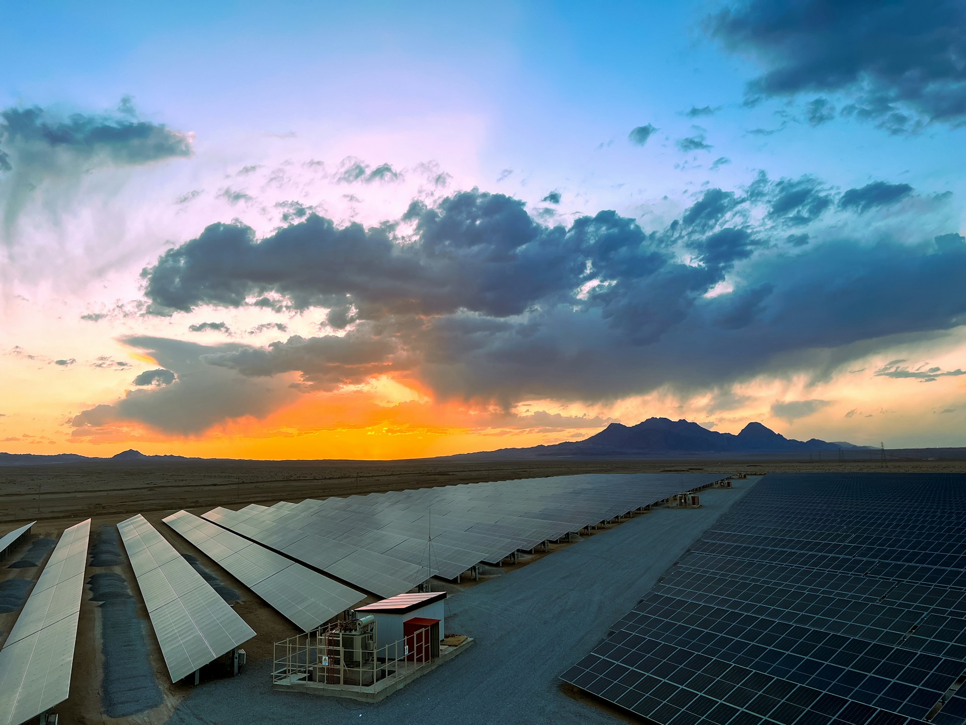 a large array of solar panels in a desert