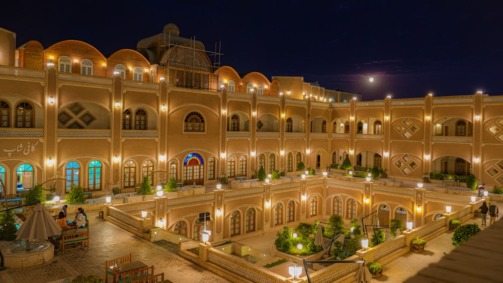 a large building lit up at night with a lot of windows