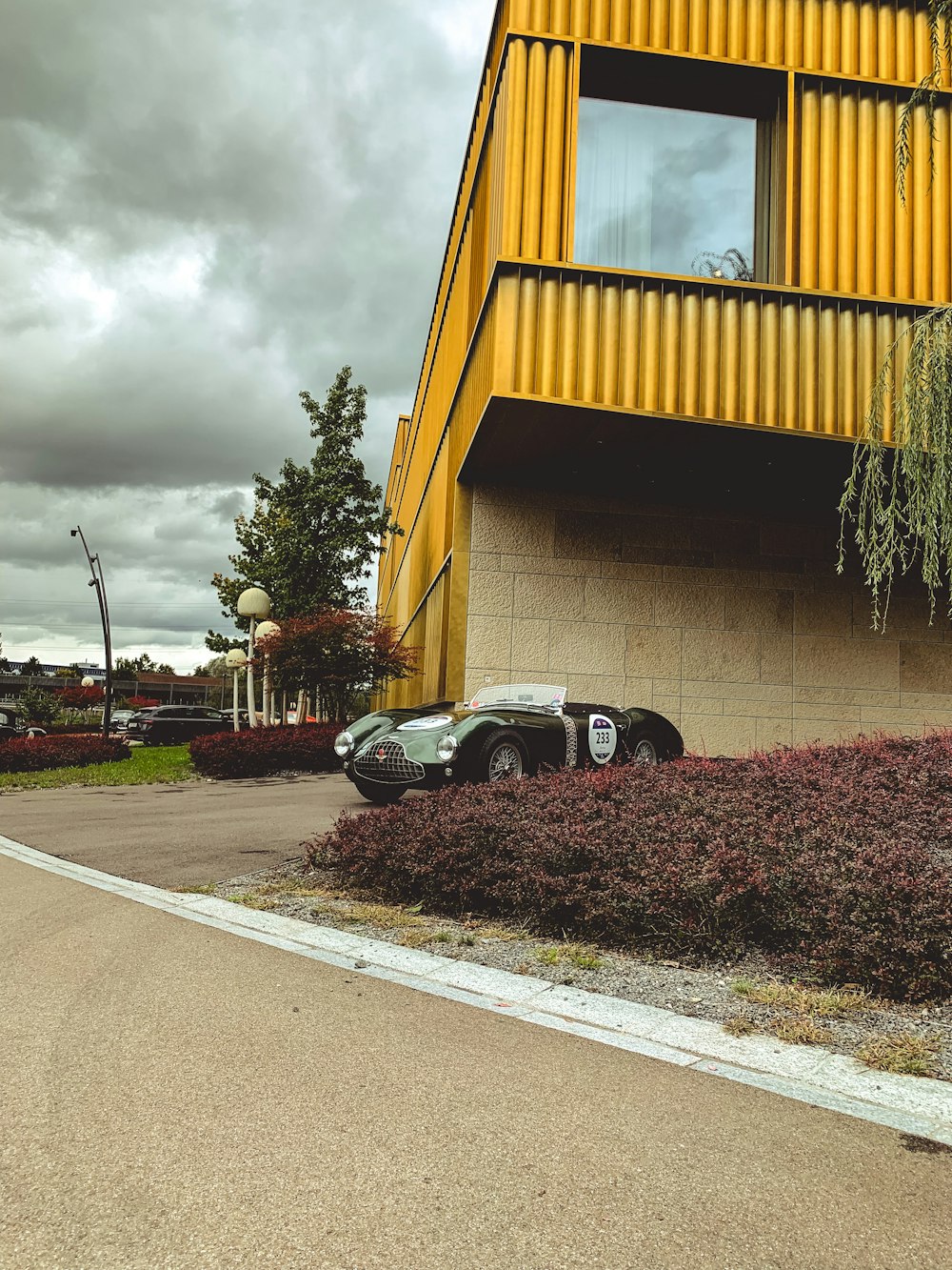 two cars parked in front of a yellow building