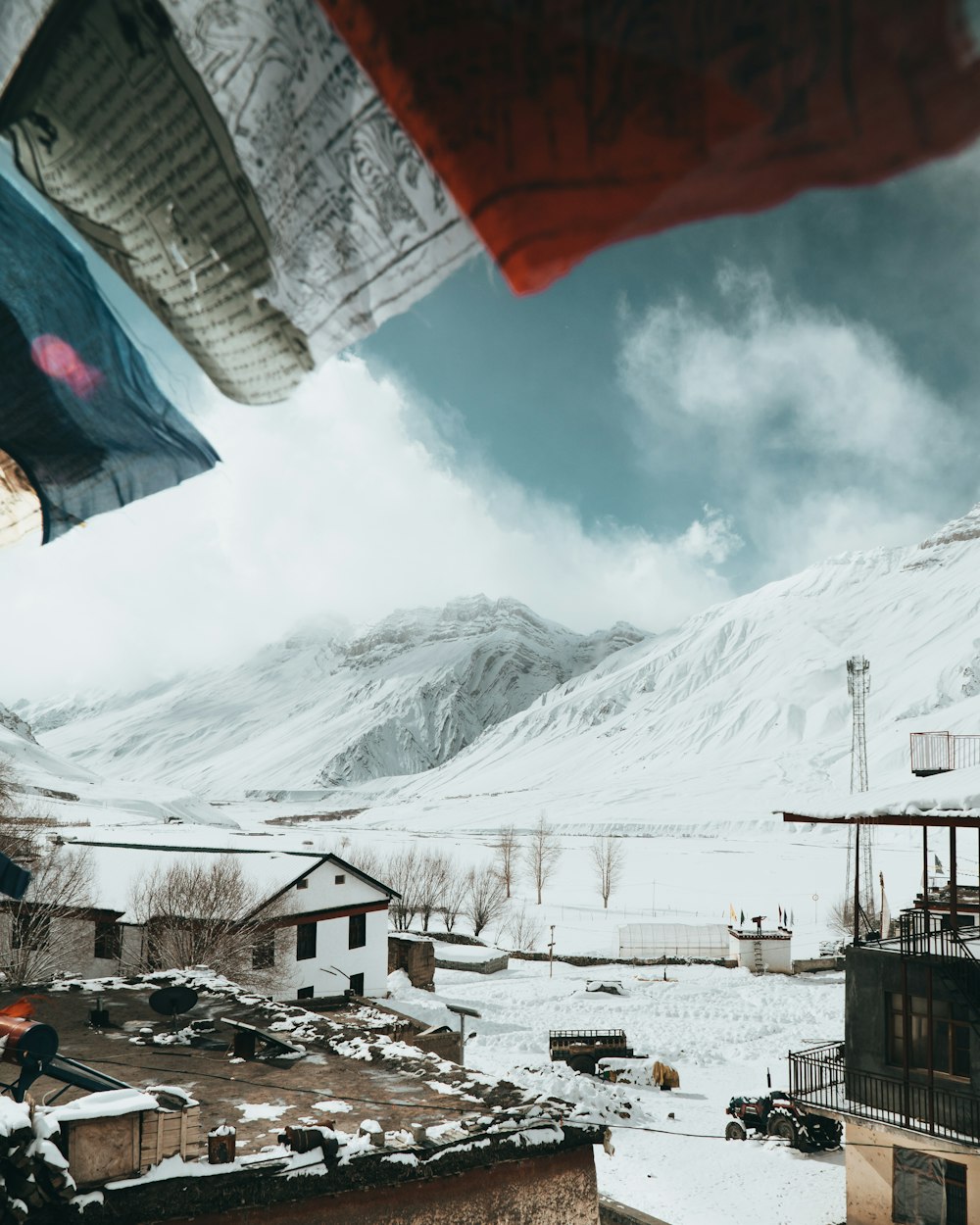 a view of a snow covered mountain from a rooftop