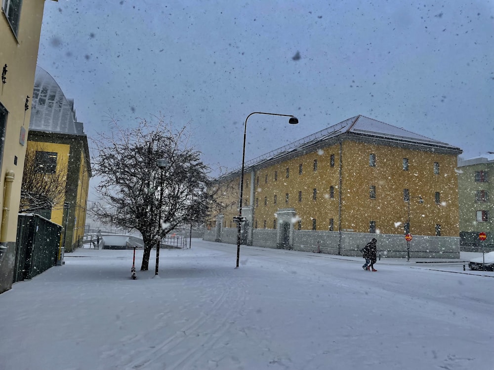 a person walking down a snow covered street