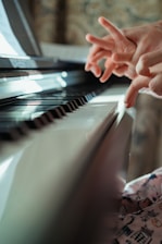 a person touching a piano with their hands