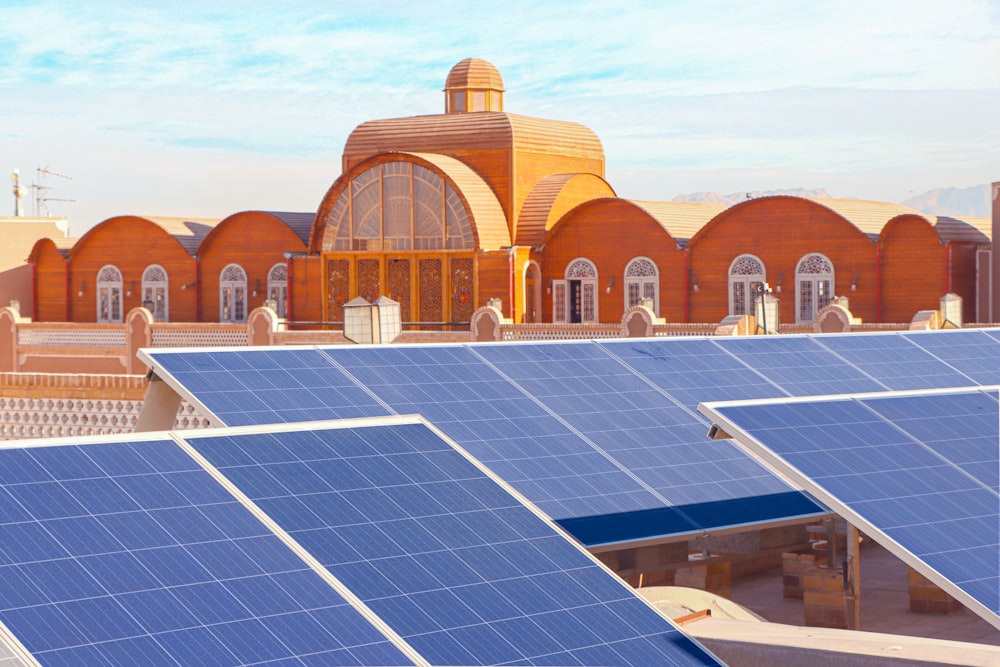 a row of solar panels in front of a building