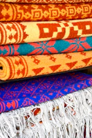 Finished rugs neatly stacked and ready for worldwide export in the factory warehouse.