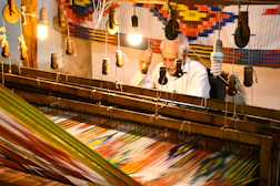 a man is working on a weaving machine