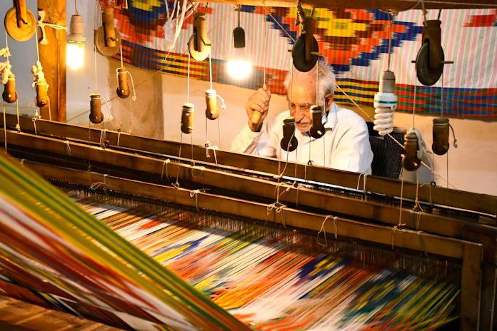 a man is working on a weaving machine