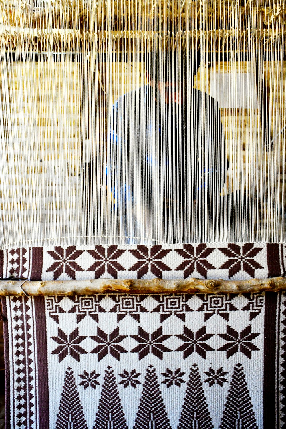 a weaving machine with a person in the background