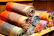 Colorful rolls of fabric stacked in a cozy workshop with natural light.