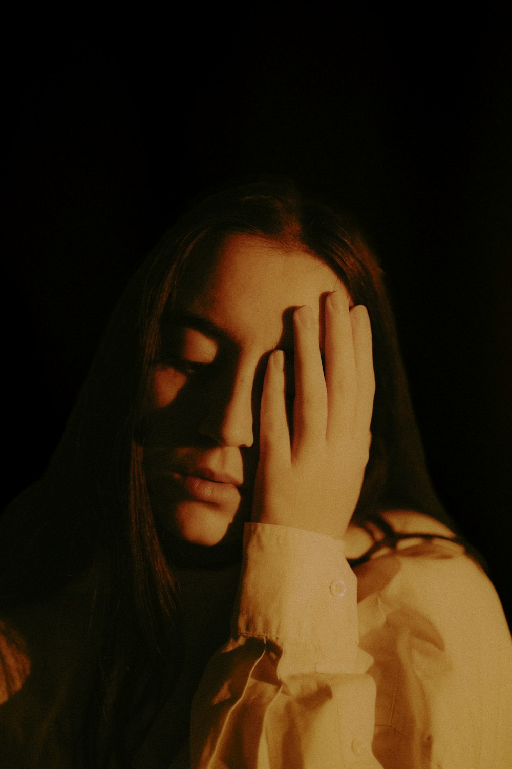 a woman covers her face with her hands