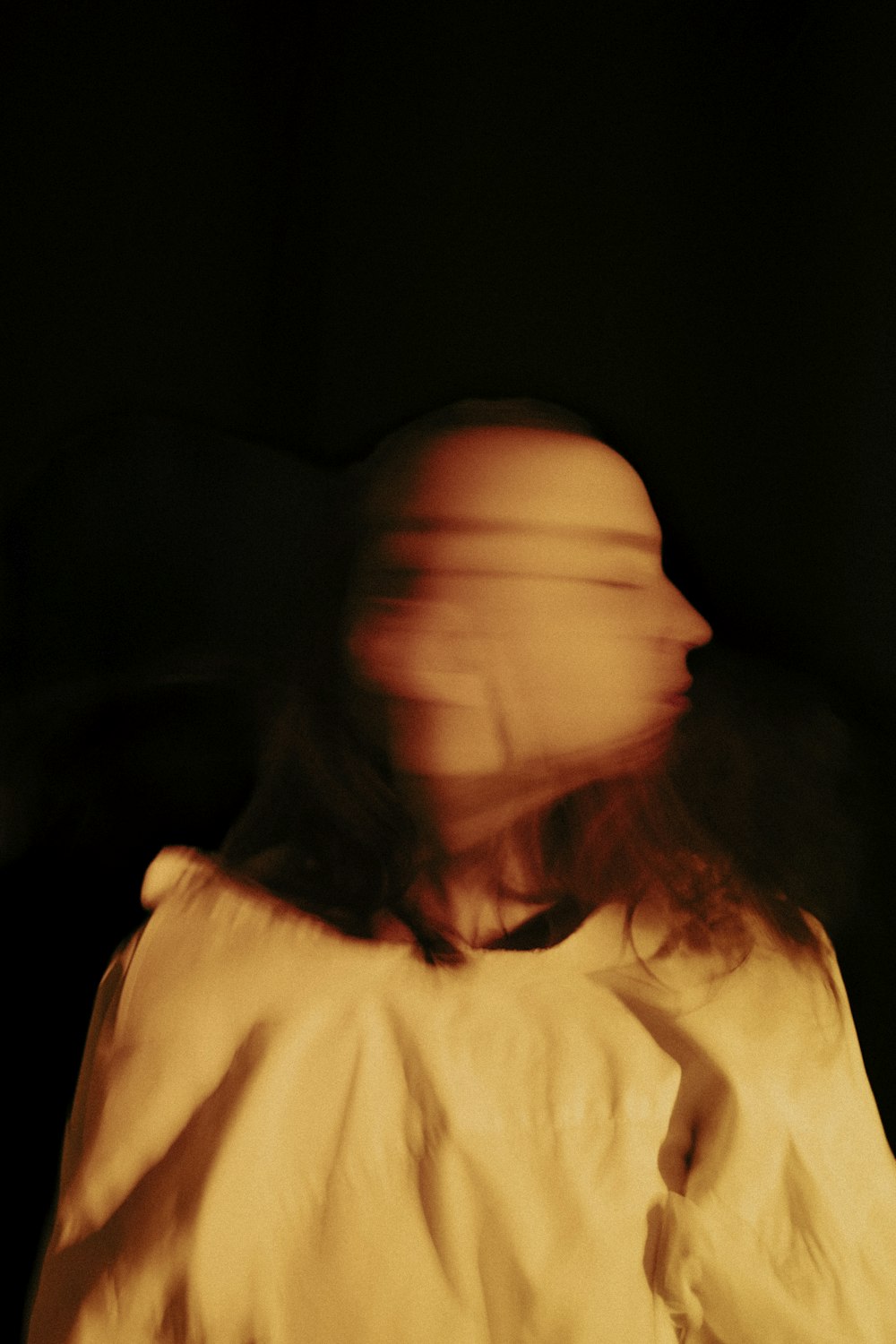 a blurry image of a person in a white shirt