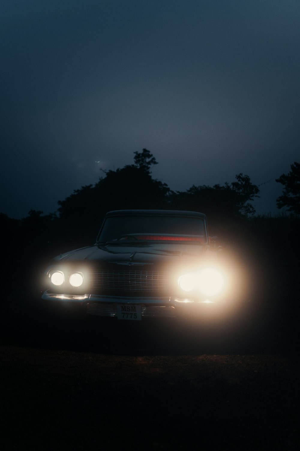 a car driving down a road at night