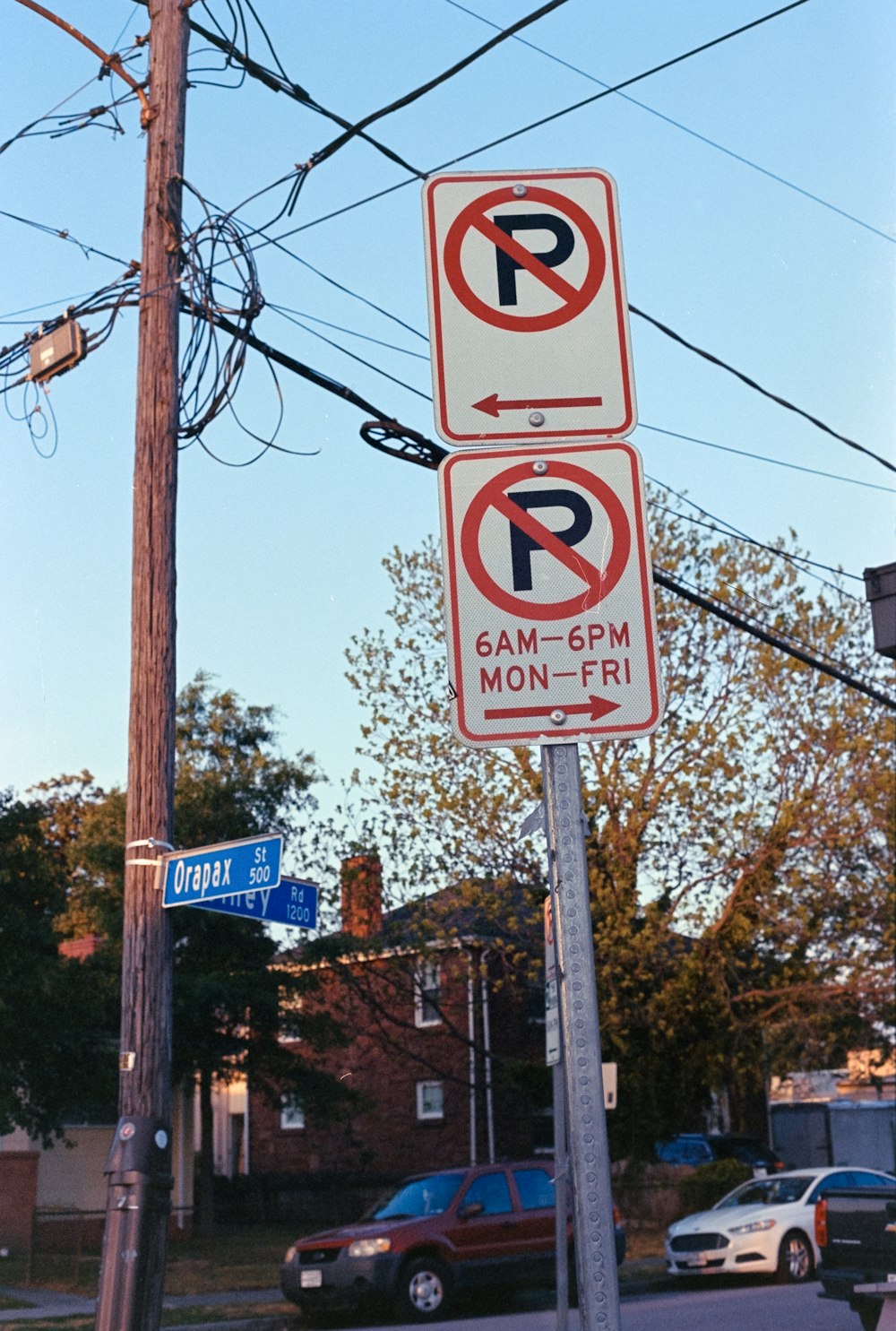 a no parking sign on a street corner