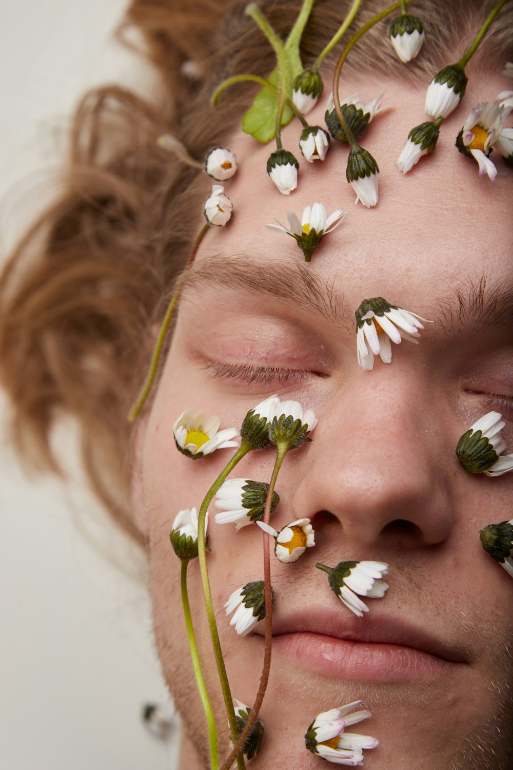 a man with flowers all over his face