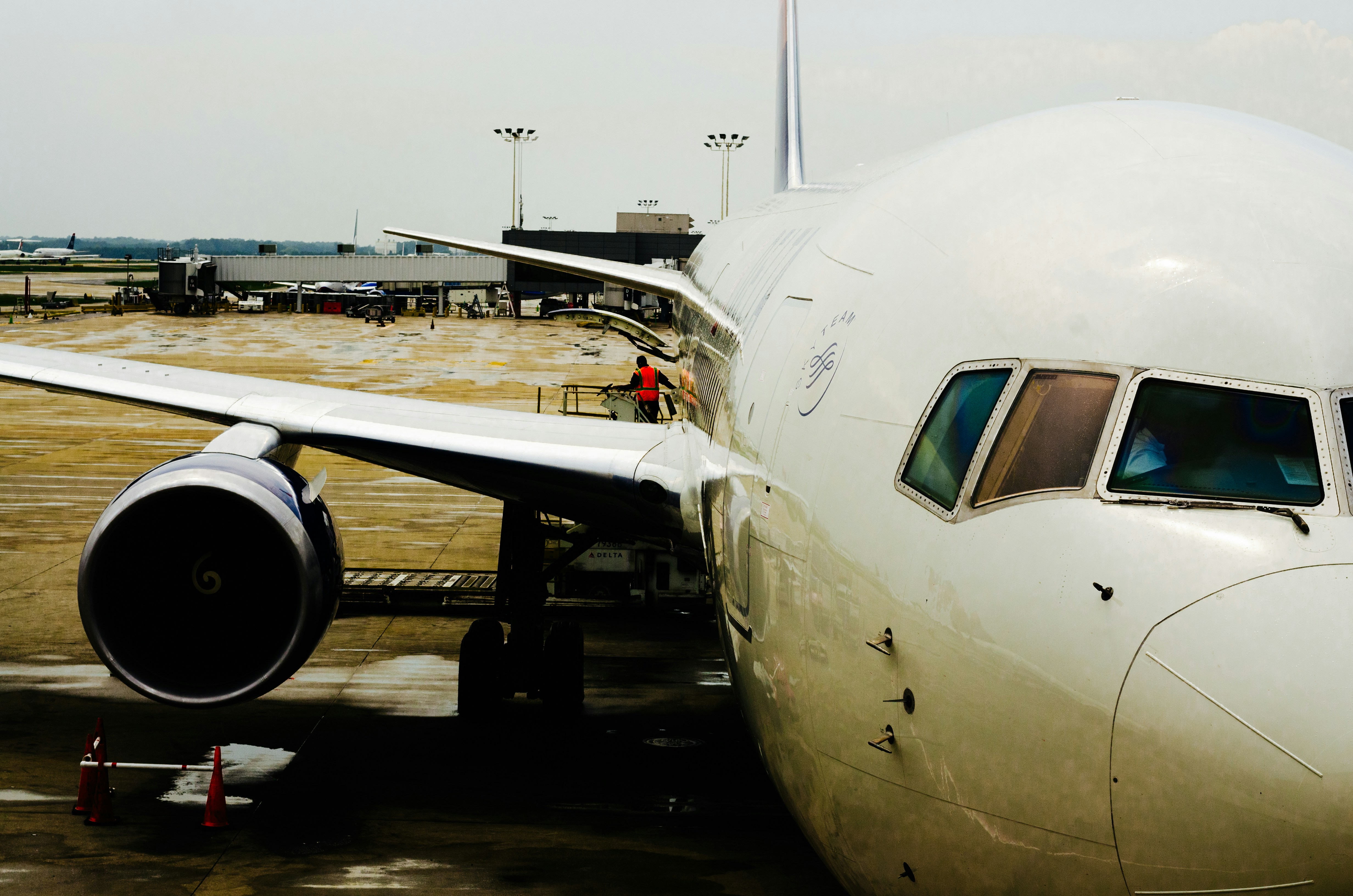 a large jetliner sitting on top of an airport tarmac, Delta Airlines at the Gate Waiting to Depart