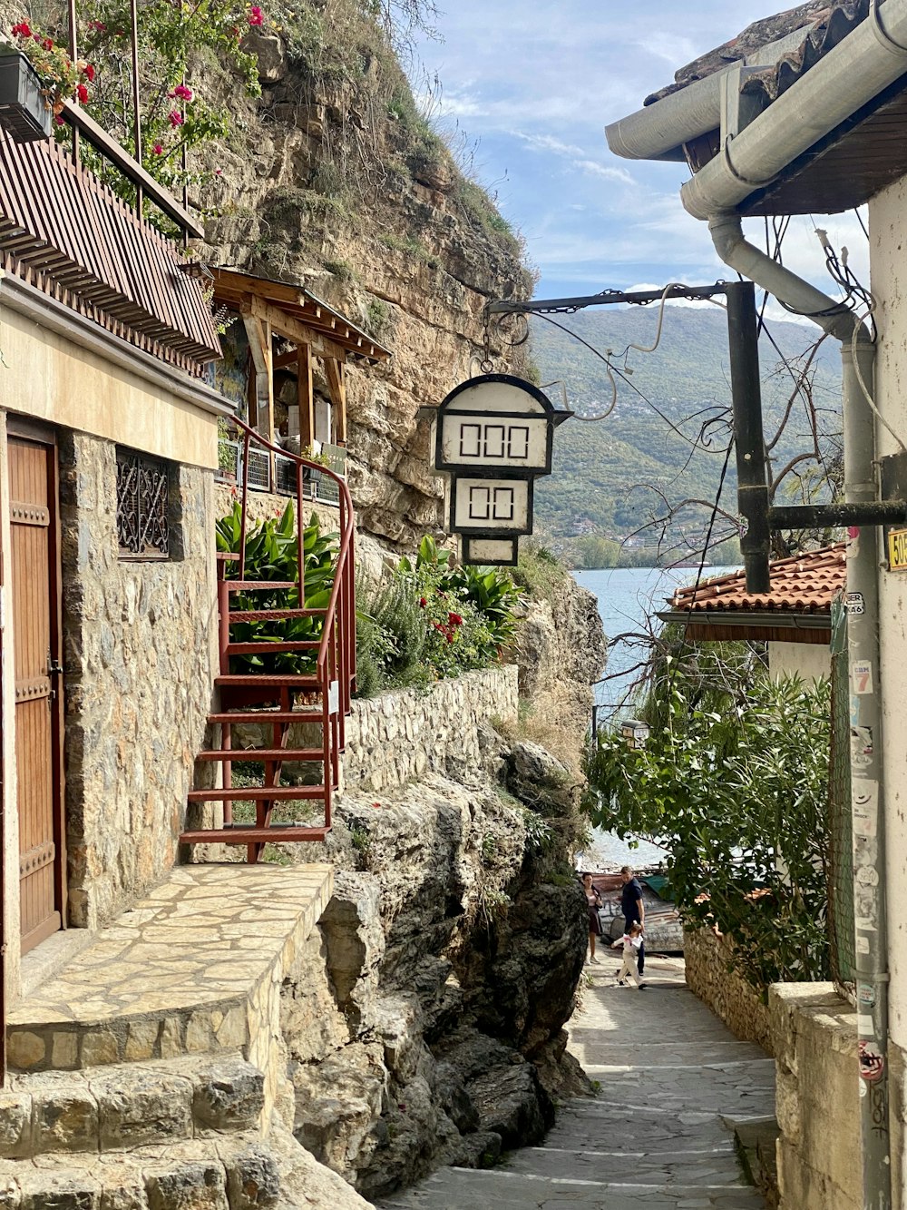 a narrow street with steps leading up to a building