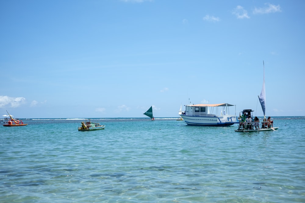 a group of boats floating on top of a large body of water