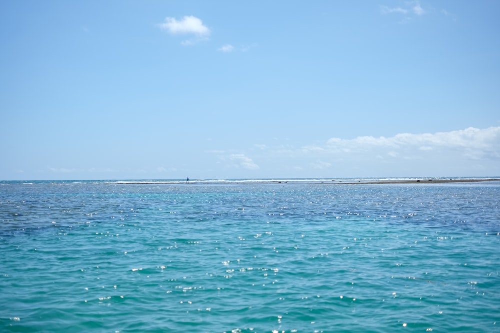 a body of water with a boat in the distance