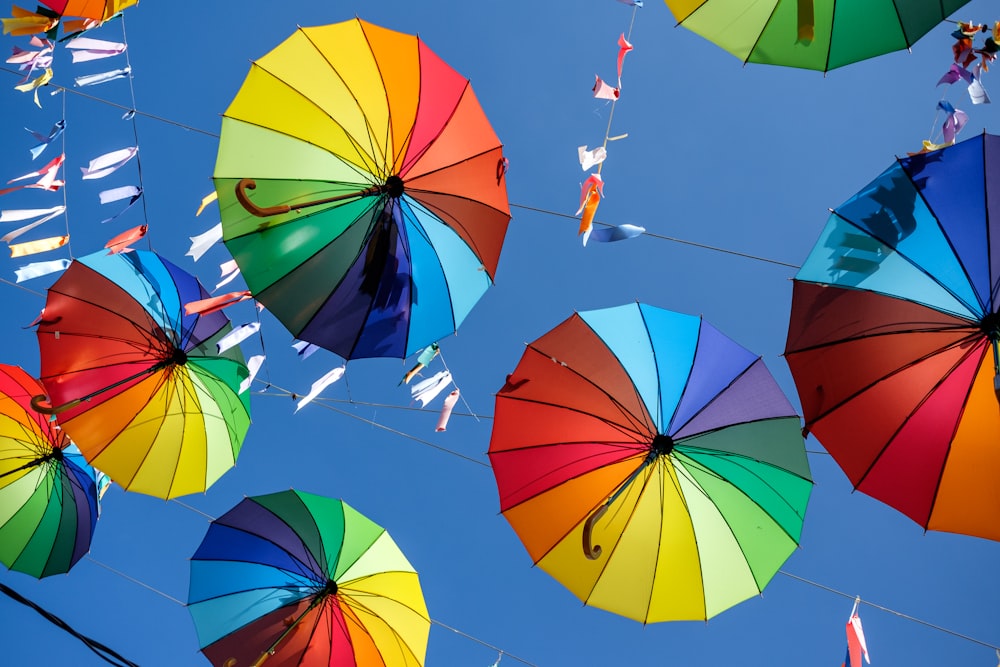 a group of colorful umbrellas hanging from a wire