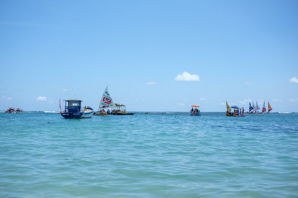 a group of boats floating on top of a large body of water