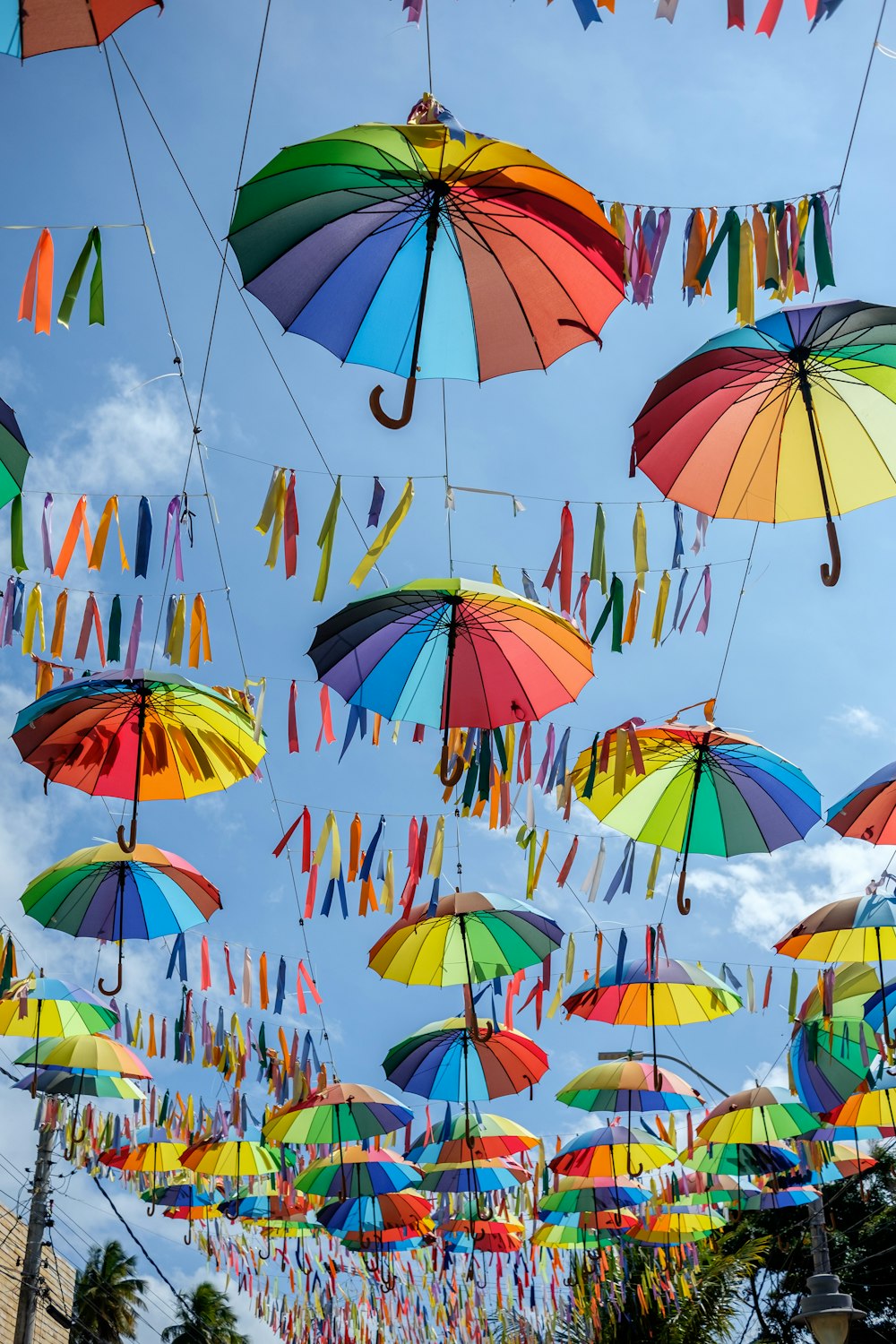 a bunch of colorful umbrellas hanging in the air