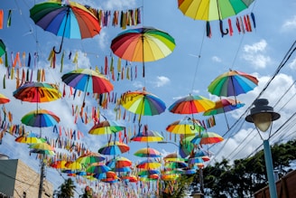 a bunch of umbrellas that are hanging in the air