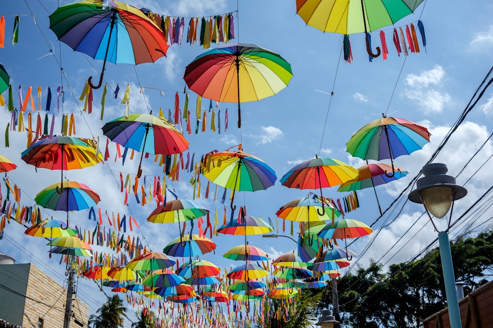 a bunch of umbrellas that are hanging in the air