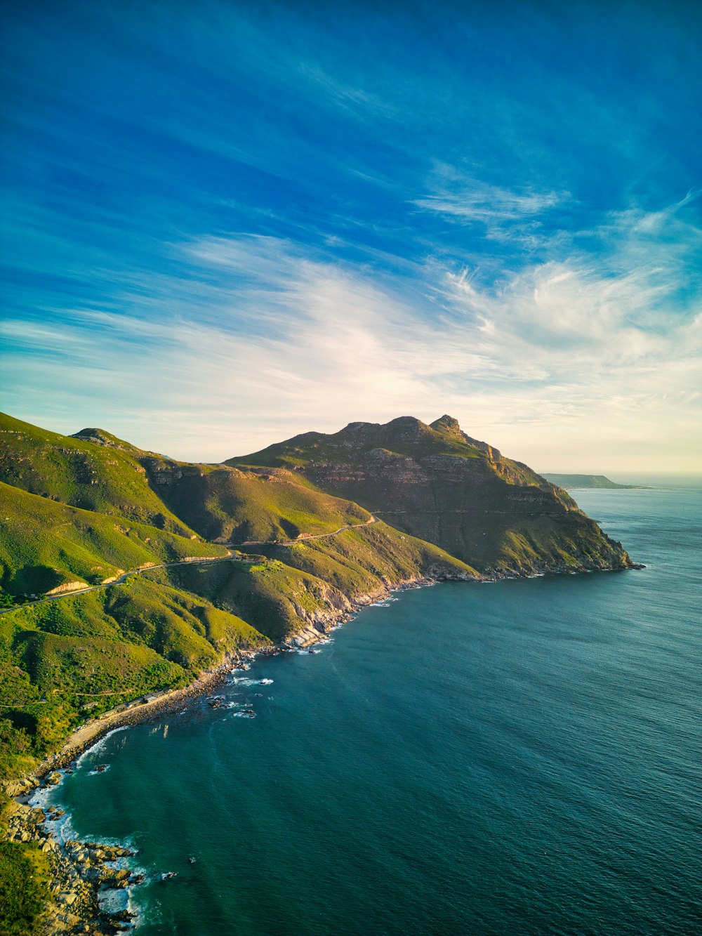 a scenic view of the ocean and mountains