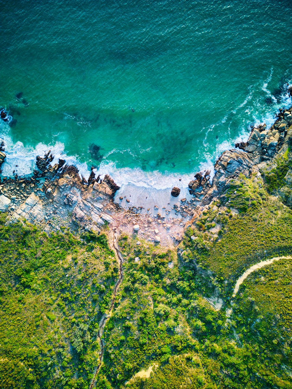 an aerial view of the ocean and land