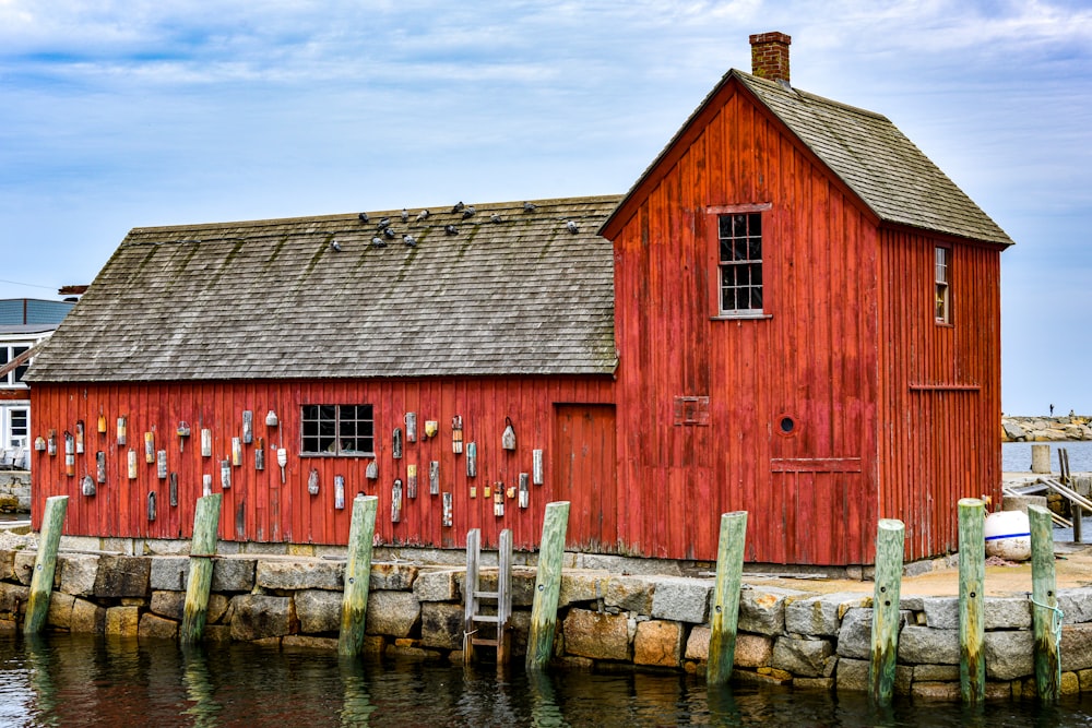 a red building sitting next to a body of water