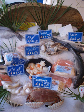 A display of frozen seafood and vegetables packaged for wholesale.