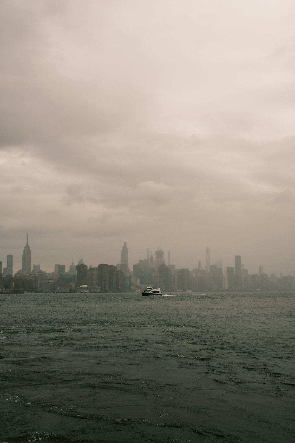 a large body of water with a city in the background