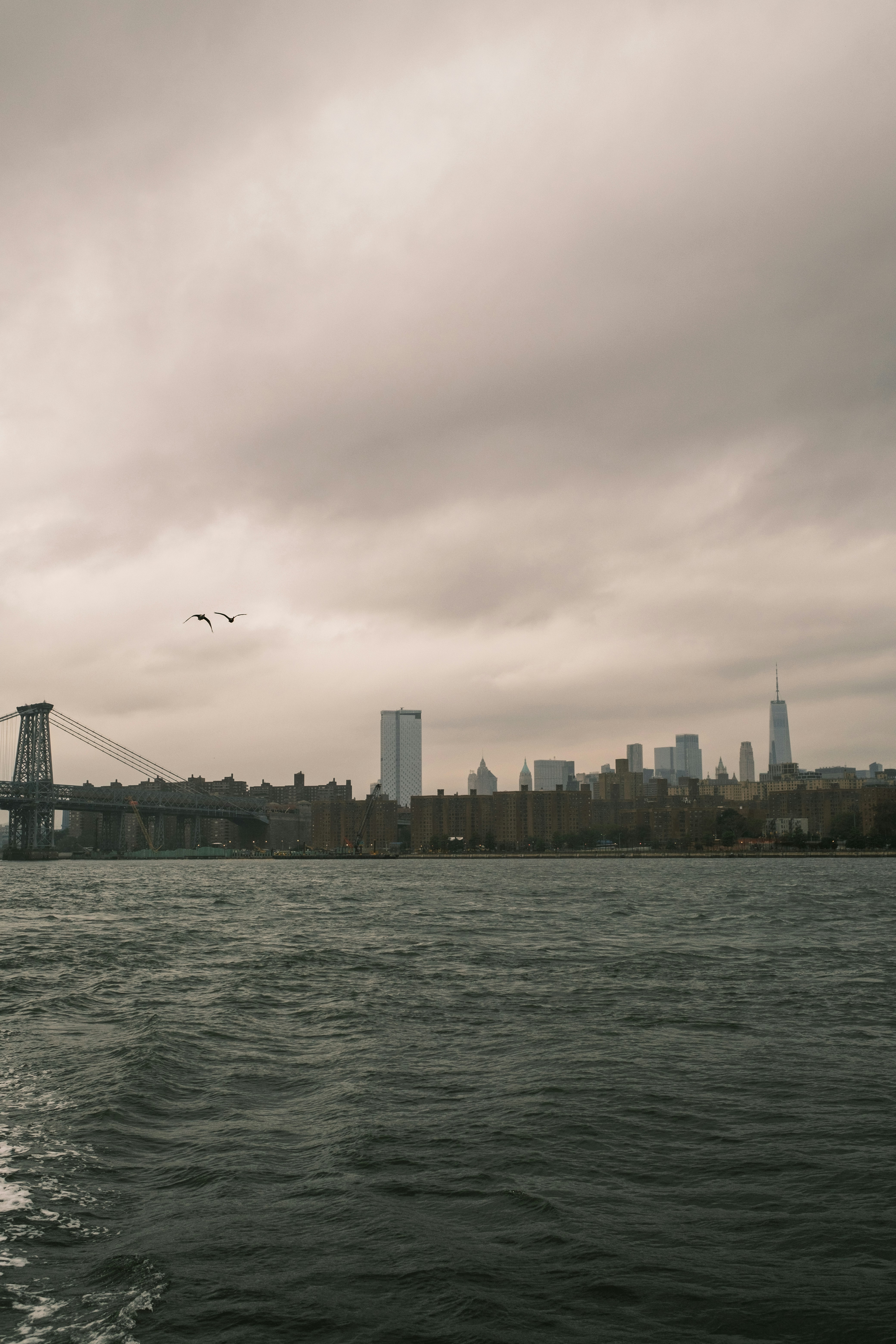 a large body of water with a bridge in the background