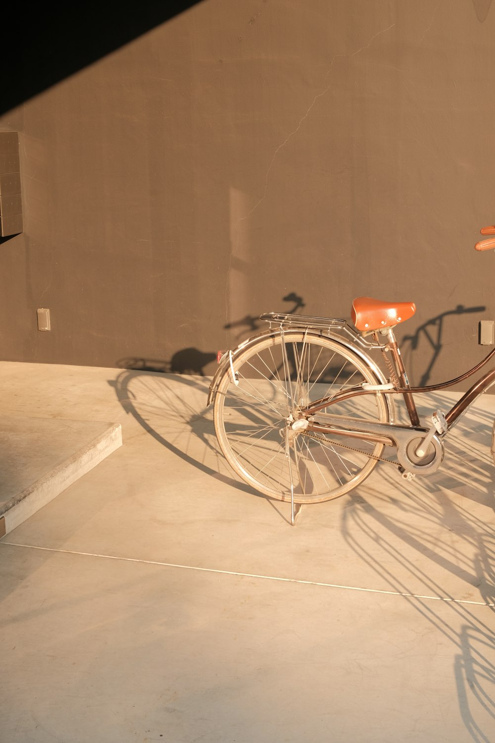 a bicycle is parked on a cement surface