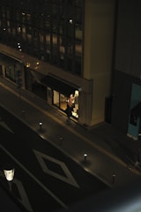 Smart streetlights adjusting brightness based on pedestrian movement at night.