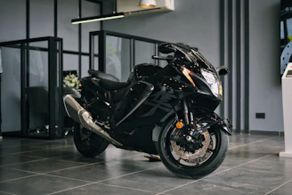 User interacting with a sleek dark mode website showing motorcycle listings and FIPE prices.