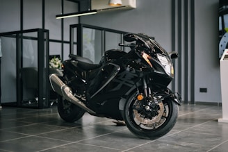 A sleek new motorcycle displayed in a modern showroom with polished floors and bright lighting.