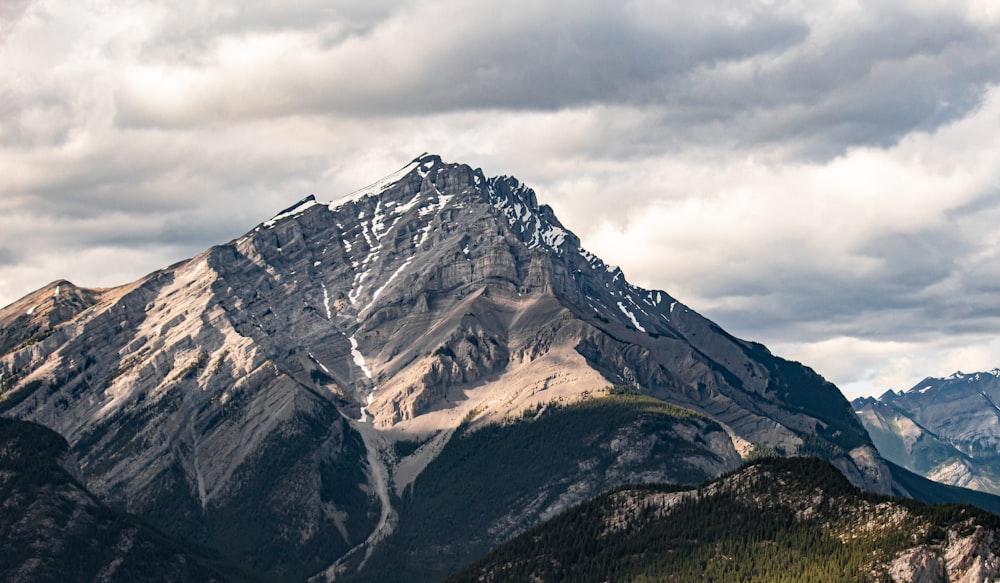 a view of a mountain range with clouds in the sky