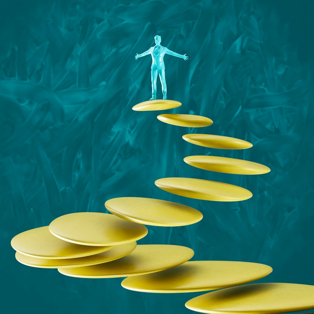 a man standing on top of a set of yellow plates