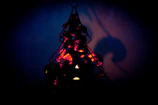 Close-up of a delicate metal lantern with intricate cut-out patterns glowing softly.