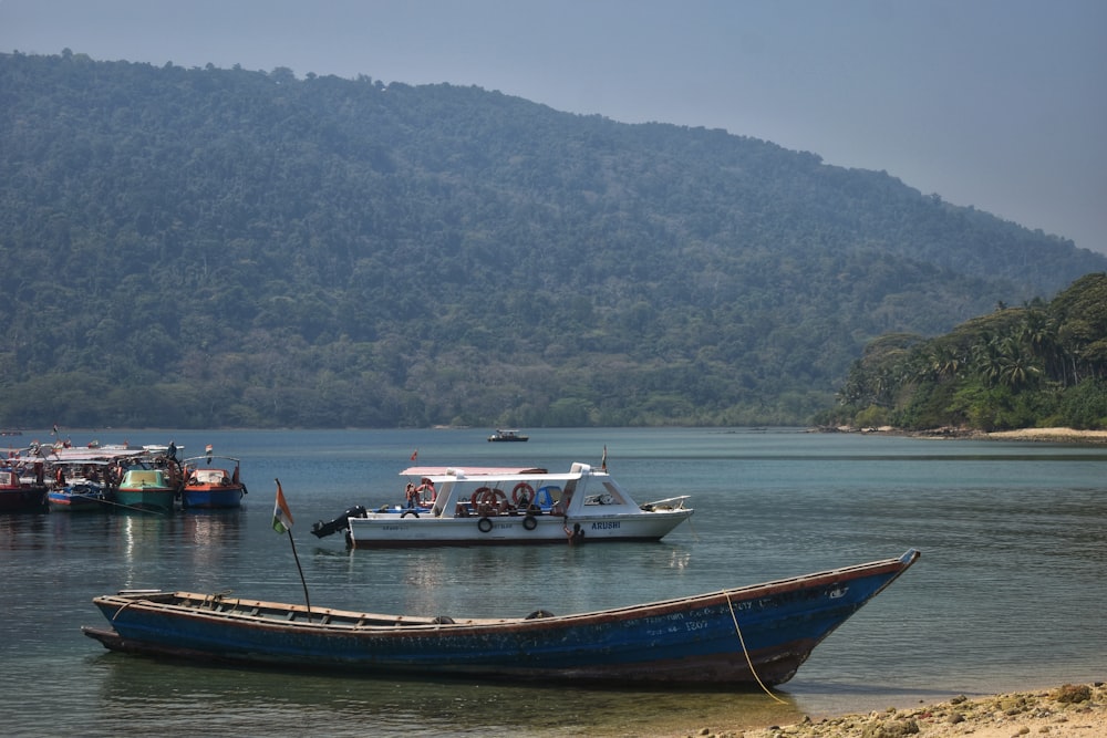 a group of boats floating on top of a lake