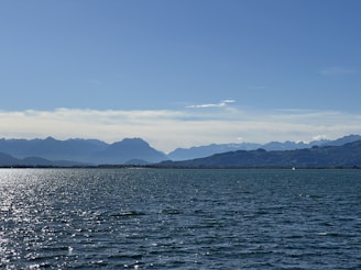 a large body of water with mountains in the background