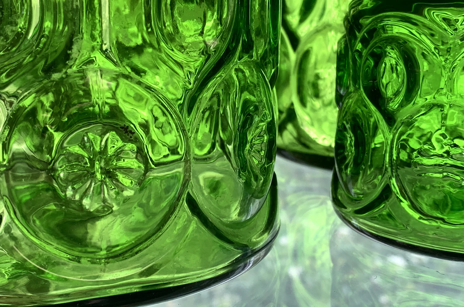 Close view of emerald-green moulded glass catching the light